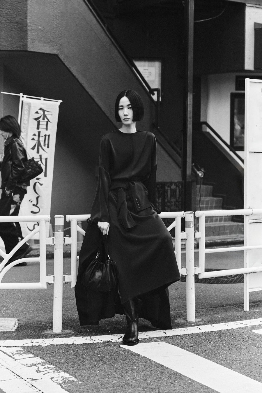 Tsugumi wears the Sisco Dress in Bistre with the Jude Knee High Boot & Tobey Bag.