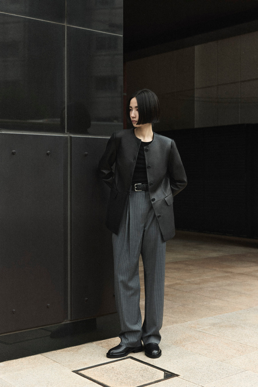 Tsugumi wears the Esme Leather Jacket, Goddard Pant in Charcoal Pinstripe and Easton Boot.