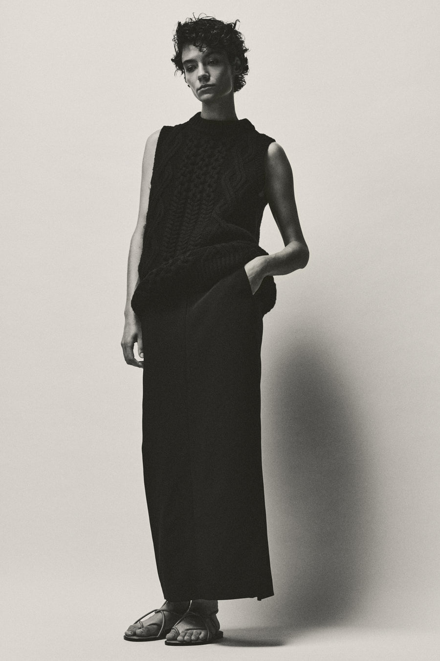 Anna Lee wears the Owen Knit with the Adrien Skirt and the Odine Sandal.