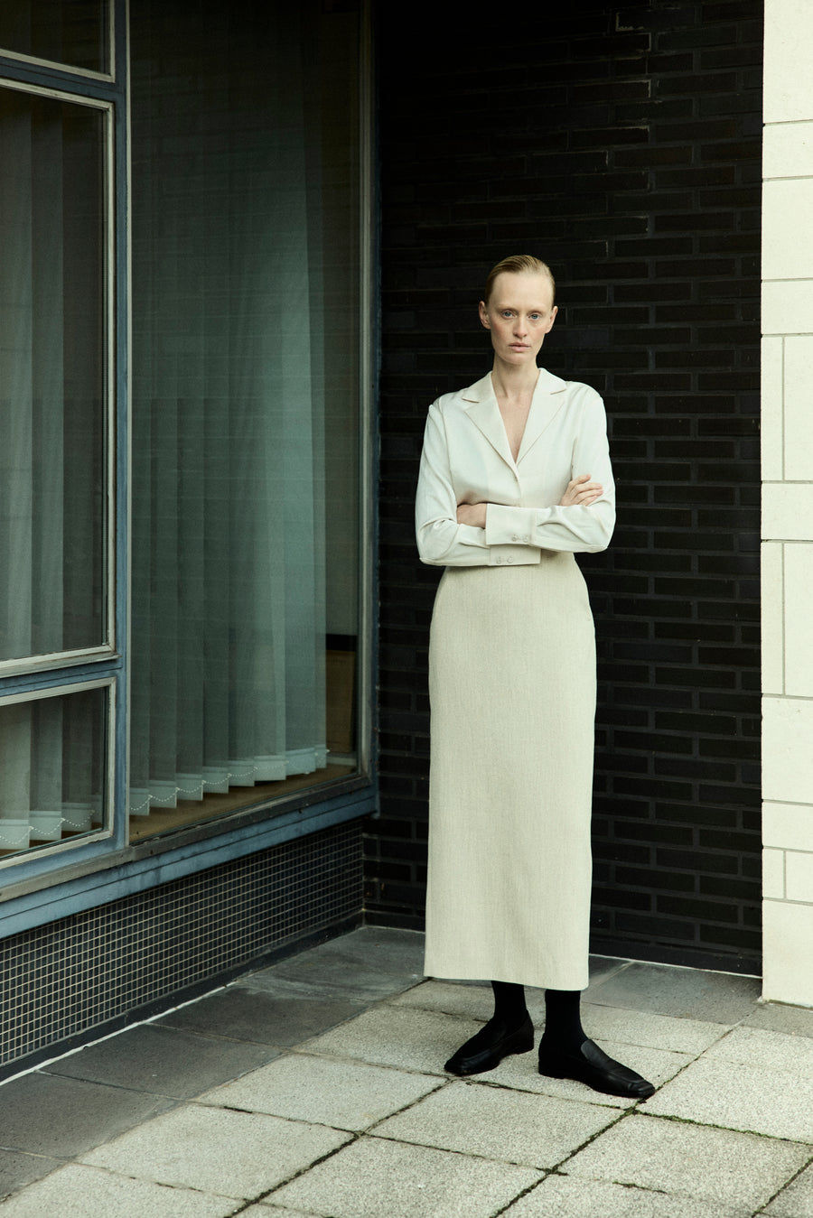 Luca wears the Elijah Shirt in Oyster, Innes Skirt in Bone and the Lane Loafer in Black