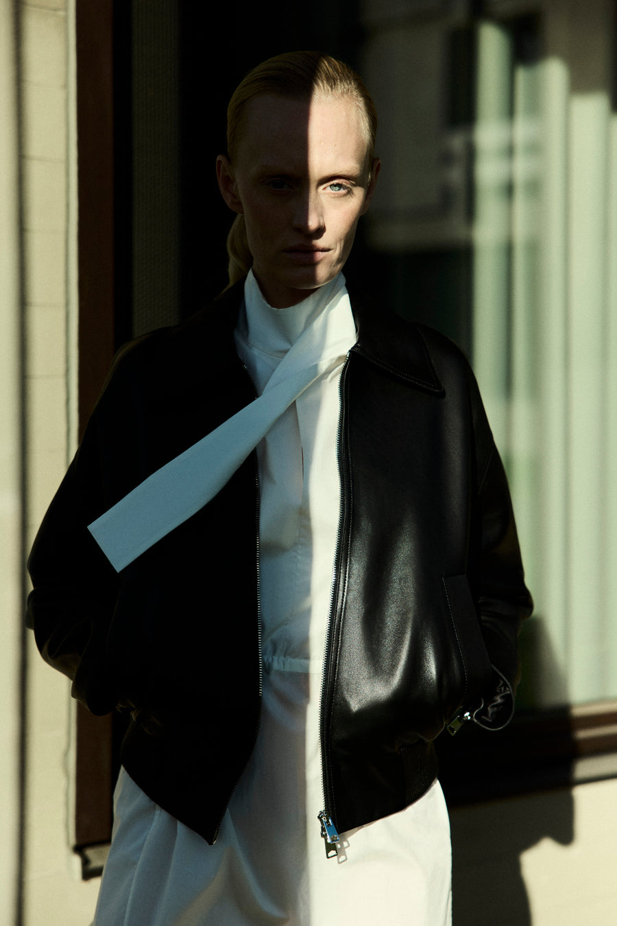 Luca wears the Vroman Leather Jacket in Black & the Ezra Dress in Parchment